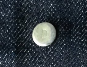 Button stamped D